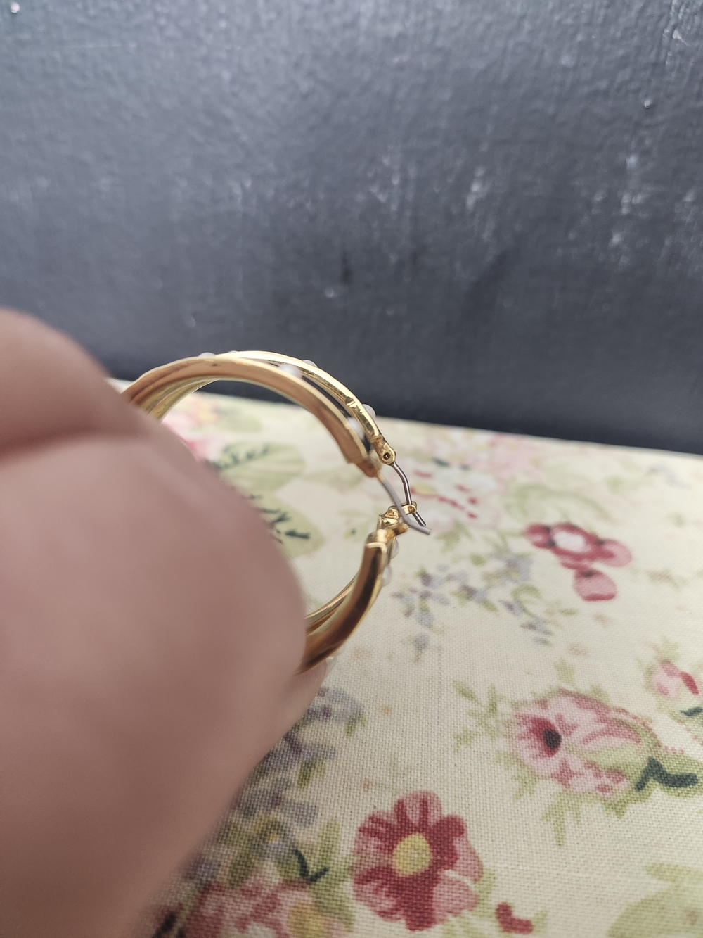 gold-tone hoop earrings with a black enamel band inlaid with round faux pearls